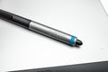 Close-up of a Wacom stylus on a graphic tablet.