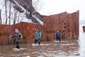 Three people wading out of water after a St. Lawrence River flash flood in the Cap-Rouge sector