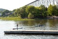 Woman on paddle board and man in kayak moving into the Cap-Rouge River from the St. Lawrence River