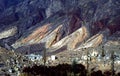 Quebrada deep valley de Humahuaca, Argentine: impressive view of a little town cemetery at the foot of the rocky coloured hills