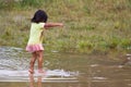 Quechua girl jumps playfully in water