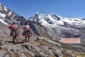 Quechua girls admire Andean mountain views on the Ausangate trail. Cusco, Peru