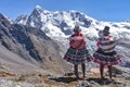 Quechua girls admire Andean mountain views on the Ausangate trail. Cusco, Peru