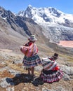 Quechua girls admire Andean mountain views on the Ausangate trail. Cusco, Peru