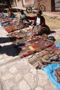 Quechua Indian woman sell colorful handmade blankets