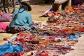 Quechua Indian woman selling colorful handmade blankets