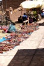 Quechua Indian woman selling colorful handmade blankets