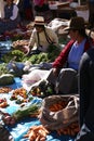 Quechua Indian women bargain and sell vegetables >