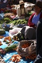 Quechua Indian women bargain and sell vegetables >