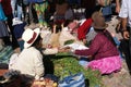 Quechua Indian women bargain and sell vegetables >