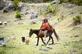 A Quechua lady rides her mule on the Inca Trail, Cusco, Peru