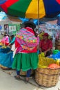 Quechua woman in traditional cloth at the food market Royalty Free Stock Photo