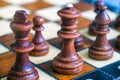 Queen and King in the foreground. Color photo of chess Board and chess pieces, wooden chess pieces on the chessboard.Soft focus. B Royalty Free Stock Photo