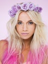 The queen of pinks and purples. Studio shot of a beautiful young woman wearing a flower crown. Royalty Free Stock Photo