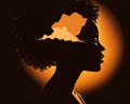 Queenly glow An elegant African American woman silhouette is highlighted in the golden light of a setting sun forever in