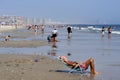 Beach goers enjoying the sun, sand and surf at Rockaway Beach, Queens, NYC on a hot summer day