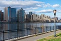 Queensbridge Park with a Street Light along the East River with the Roosevelt Island Skyline in New York City Royalty Free Stock Photo