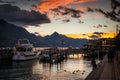 People on the pier watching beautiful sunset over the lake Wakatipu. Royalty Free Stock Photo