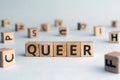 Queer - word from wooden blocks with letters