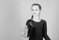 Quench thirst. Child feel thirst after sport training. Kid cute girl gymnast sports leotard hold bottle for drink. Water