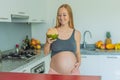 Quenching her pregnancy thirst with a refreshing choice, a pregnant woman joyfully drinks coconut water from a coconut Royalty Free Stock Photo