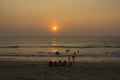 Big indian family on the beach at sunset time. women in colorful sarees
