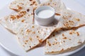 Quesadilla with beef and chicken on a white plate. quesadilla and sauce. Royalty Free Stock Photo