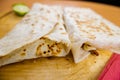 Quesadillas and a slice of lime on a cutting board