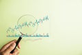 Unlocking the secrets of the stock market, a trader inspects the bar graph's increasing arrow Royalty Free Stock Photo