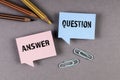 Question and Answer concept. Speech bubbles and pencils on a gray background