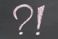Question exclamation mark. Pink chalk sign on black slate-based design handmade Royalty Free Stock Photo