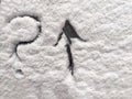 A question mark and arrow written in the snow. The cold frosty texture of the snow and the question mark. Background Royalty Free Stock Photo