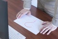 Question mark on a blank sheet. On the table of a businessman. Monitor and keyboard