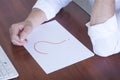 Question mark on a blank sheet. On the table of a businessman. Monitor and keyboard