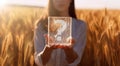 A question mark etched on a glass rectangle being held by a young beautiful woman.