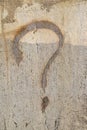 Question Mark in gold paint on grungy cracked and dirty concrete background