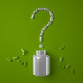 Question mark made from capsules and a white jar on a green background. Royalty Free Stock Photo