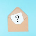 Question mark on a paper in an envelope, education and business concept, searching for answers, thoughts for solving a problem Royalty Free Stock Photo