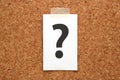 Question mark on a piece of paper on a cork board. Royalty Free Stock Photo