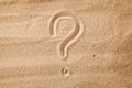 The question mark is sand painted on sand. Symbol of choice and doubt Royalty Free Stock Photo