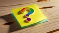 Question Mark Sticky Note, Vibrant Design on Textured Wood Background Royalty Free Stock Photo