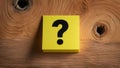 Question Mark Sticky Note, Vibrant Design on Textured Wood Background Royalty Free Stock Photo