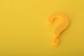 The question mark symbol isolated on a yellow background acts as a beacon, inviting people to make inquiries and explore knowledge