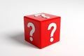 Question mark symbols on a red dice on white background. 3D render