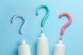 Question mark from toothpaste. Concept of choosing good toothpaste for teeth whitening. Tube of colored toothpaste on