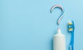 Question mark from toothpaste. The concept of choosing good toothpaste for teeth whitening. Tube of colored toothpaste and