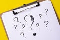 A question mark on a white sheet . FAQ frequency asked questions, Answer and Brainstorming Concepts Royalty Free Stock Photo