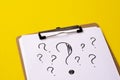 A question mark on a white sheet . FAQ frequency asked questions, Answer and Brainstorming Concepts Royalty Free Stock Photo