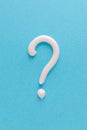 Question mark from white toothpaste on blue background Royalty Free Stock Photo