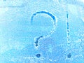 A question mark written in the snow. The cold frosty texture of the snow and the question mark. Background, place for
